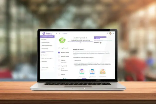 Laptop asztalon szemből, megynitott szerzi megbízási szerződéssel